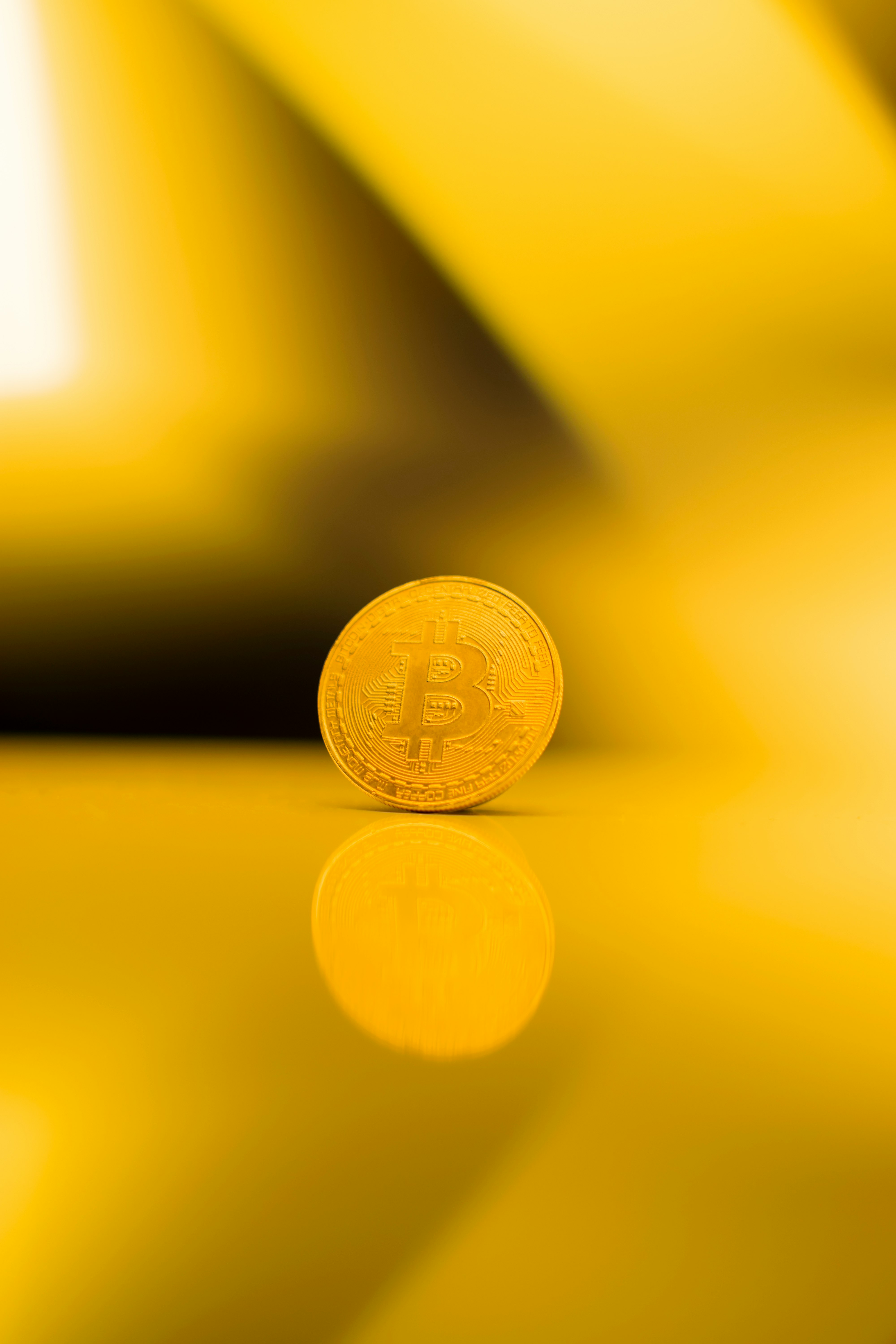 gold round coin on yellow surface